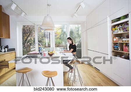 Caucasian girl doing homework in domestic kitchen View Large Photo Image Stock Image - Caucasian girl doing homework in domestic kitchen. Fotosearch