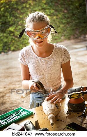 Caucasian girl hammering nails into birdhouse View Large Photo Image Stock Photo - Caucasian girl hammering nails into birdhouse. Fotosearch