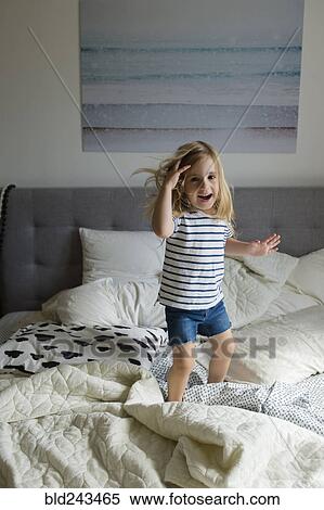 Caucasian girl jumping on bed View Large Photo Image Stock Photography - Caucasian girl jumping on bed. Fotosearch