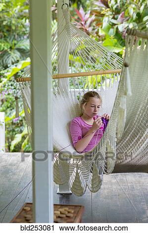Caucasian girl laying in hammock and knitting View Large Photo Image Stock Image - Caucasian girl laying in hammock and knitting. Fotosearch