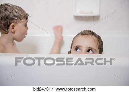 Caucasian girl peaking from bathtub View Large Photo Image Stock Photo - Caucasian girl peaking from bathtub. Fotosearch