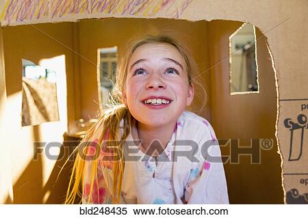 Caucasian girl playing in cardboard house View Large Photo Image Stock Photography - Caucasian girl playing in cardboard house. Fotosearch