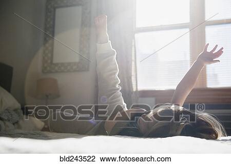 Caucasian girl playing on bed View Large Photo Image Stock Image - Caucasian girl playing on bed. Fotosearch