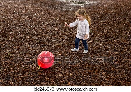 Caucasian girl playing with red ball in autumn View Large Photo Image Stock Image - Caucasian girl playing with red ball in autumn. Fotosearch