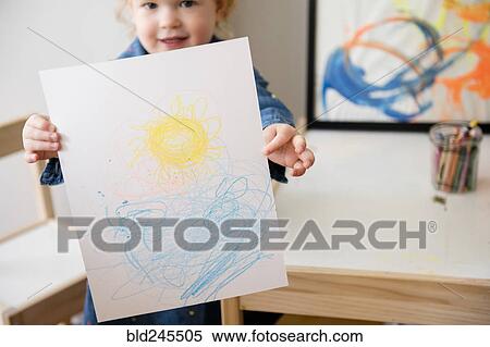 Stock Photography - Caucasian girl showing drawing on paper. Fotosearch
