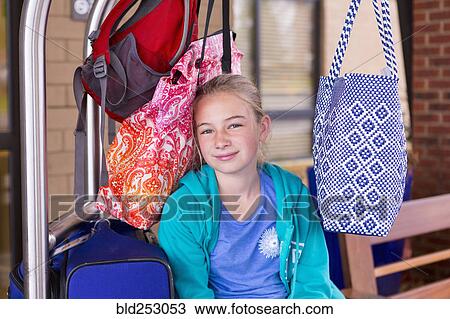 Caucasian girl sitting on luggage rack View Large Photo Image Stock Image - Caucasian girl sitting on luggage rack. Fotosearch