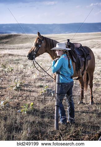 Caucasian girl standing in field with horse View Large Photo Image Stock Photo - Caucasian girl standing in field with horse. Fotosearch