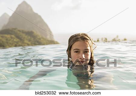 Caucasian girl swimming in infinity pool View Large Photo Image Stock Image - Caucasian girl swimming in infinity pool. Fotosearch