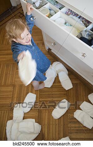 Caucasian girl throwing diapers on floor View Large Photo Image Stock Image - Caucasian girl throwing diapers on floor. Fotosearch