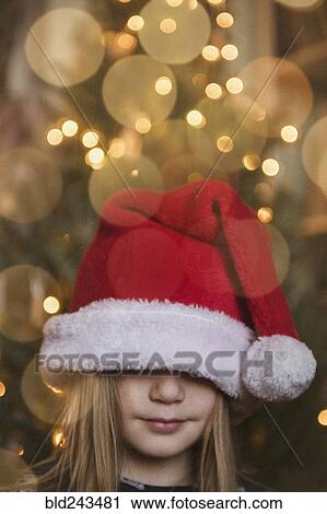 Caucasian girl wearing large Santa hat View Large Photo Image Stock Image - Caucasian girl wearing large Santa hat. Fotosearch