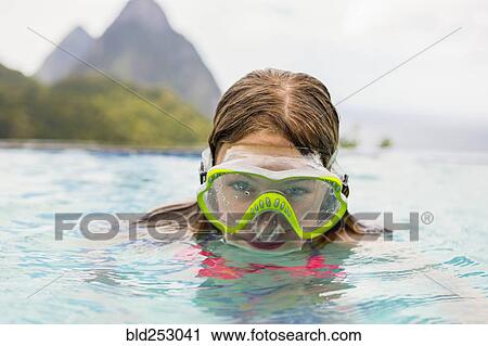 Caucasian girl wearing snorkel mask in swimming pool View Large Photo Image Stock Image - Caucasian girl wearing snorkel mask in swimming pool. Fotosearch