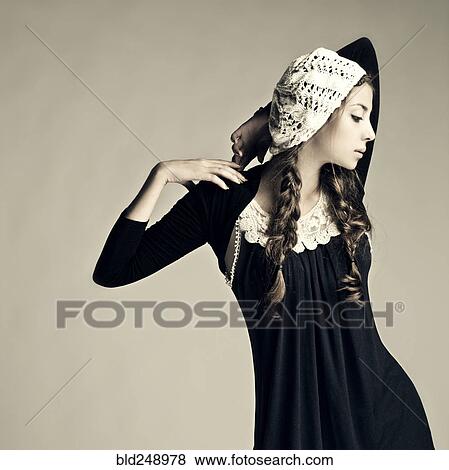 Stock Photo - Caucasian girl wearing traditional dress and hat. Fotosearch