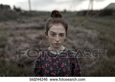 Caucasian girl with freckles raising eyebrow in field View Large Photo Image Stock Photograph - Caucasian girl with freckles raising eyebrow in field. Fotosearch