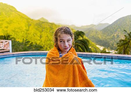Picture - Caucasian girl wrapped in towel near swimming pool. Fotosearch