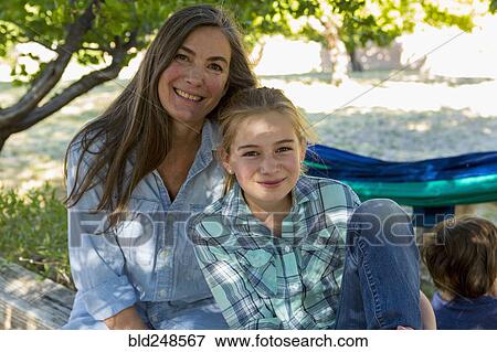 Stock Photo - Caucasian grandmother posing with granddaughter. Fotosearch