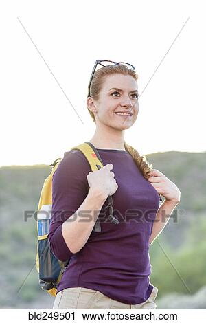 Stock Image - Caucasian hiker wearing backpack. Fotosearch