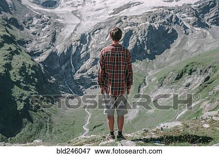 Caucasian man admiring scenic view of mountain View Large Photo Image Stock Photo - Caucasian man admiring scenic view of mountain. Fotosearch