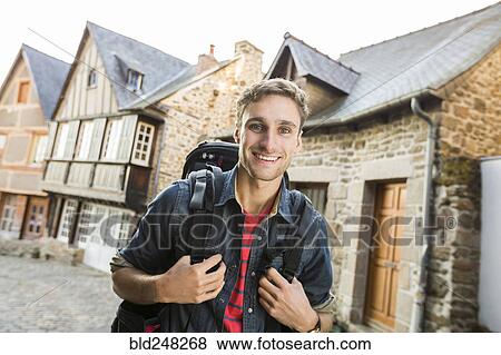 Caucasian man backpacking in city View Large Photo Image Stock Photo - Caucasian man backpacking in city. Fotosearch