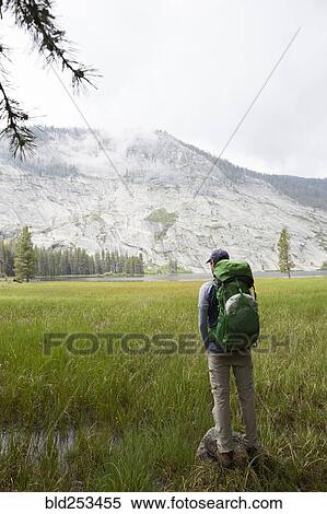 Caucasian man backpacking near mountain View Large Photo Image Stock Photography - Caucasian man backpacking near mountain. Fotosearch