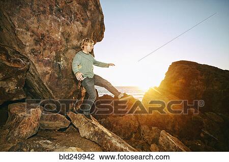Caucasian man balancing on rocks at ocean View Large Photo Image Stock Image - Caucasian man balancing on rocks at ocean. Fotosearch