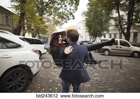 Caucasian man carrying woman on cobblestone street View Large Photo Image Stock Image - Caucasian man carrying woman on cobblestone street. Fotosearch
