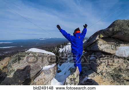 Caucasian man celebrating on mountain top in winter View Large Photo Image Stock Photo - Caucasian man celebrating on mountain top in winter. Fotosearch