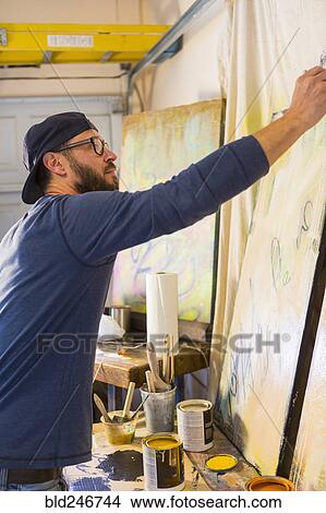 Caucasian man creating paintings View Large Photo Image Picture - Caucasian man creating paintings. Fotosearch