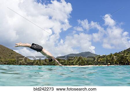 Caucasian man diving into tropical ocean View Large Photo Image Stock Image - Caucasian man diving into tropical ocean. Fotosearch
