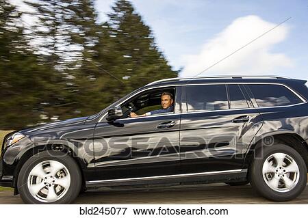 Stock Photo - Caucasian man driving car. Fotosearch