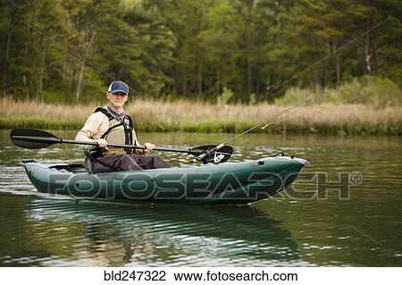 Caucasian man fishing on kayak View Large Photo Image Stock Image - Caucasian man fishing on kayak. Fotosearch