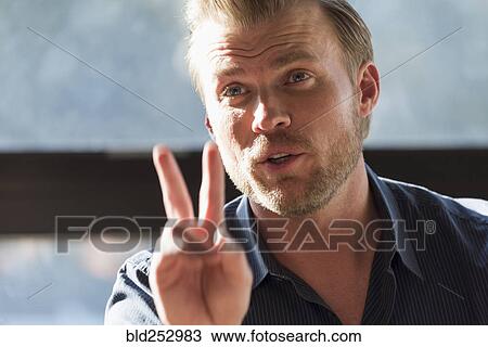 Caucasian man gesturing with fingers View Large Photo Image Stock Image - Caucasian man gesturing with fingers. Fotosearch