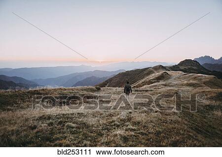 Caucasian man hiking in remote mountain landscape View Large Photo Image Stock Image - Caucasian man hiking in remote mountain landscape. Fotosearch