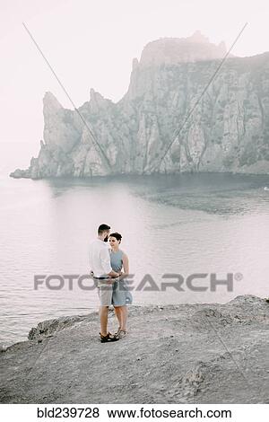 Caucasian man hugging woman at beach View Large Photo Image Stock Photo - Caucasian man hugging woman at beach. Fotosearch