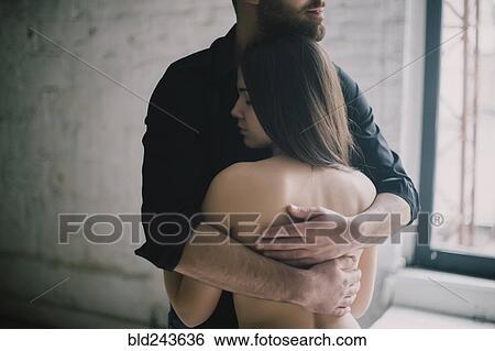 Caucasian man hugging woman with bare back View Large Photo Image Stock Photograph - Caucasian man hugging woman with bare back. Fotosearch