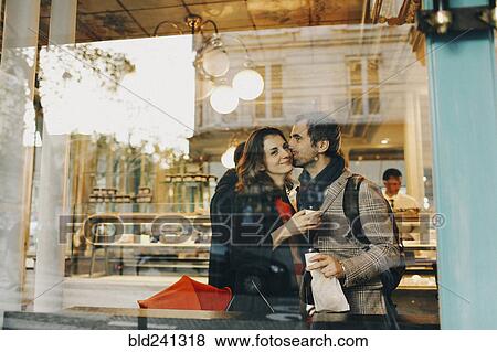 Caucasian man kissing woman on cheek behind bakery window View Large Photo Image Stock Photo - Caucasian man kissing woman on cheek behind bakery window. Fotosearch
