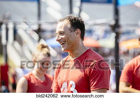 Stock Image - Caucasian man laughing outdoors. Fotosearch