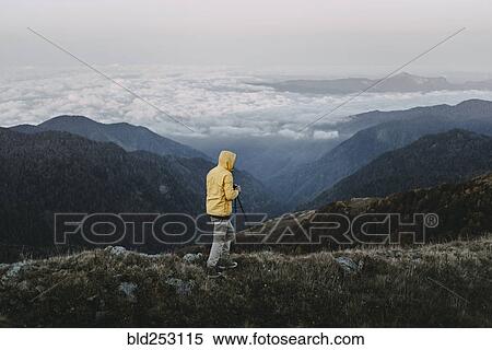 Caucasian man photographing in remote mountain landscape View Large Photo Image Stock Photography - Caucasian man photographing in remote mountain landscape. Fotosearch