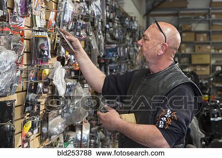 Stock Photo - Caucasian man shopping for parts. Fotosearch