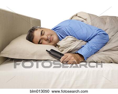 Caucasian man sleeping and holding telephone View Large Photo Image Stock Image - Caucasian man sleeping and holding telephone. Fotosearch