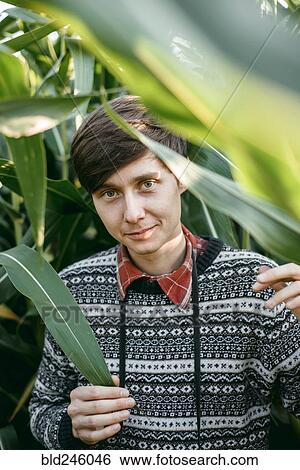 Caucasian man smiling in foliage View Large Photo Image Stock Photograph - Caucasian man smiling in foliage. Fotosearch