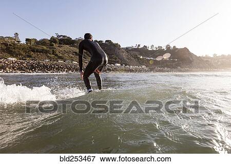 Caucasian man surfing View Large Photo Image Stock Photo - Caucasian man surfing. Fotosearch