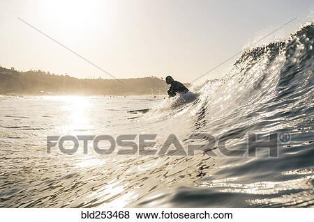 Stock Photo - Caucasian man surfing. Fotosearch