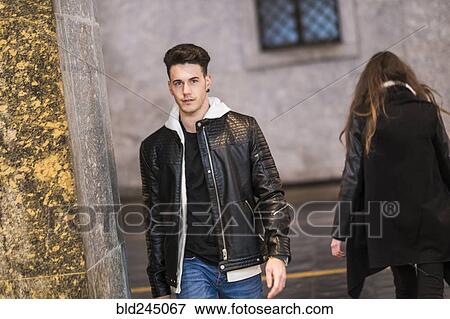 Stock Photo - Caucasian man walking in city. Fotosearch