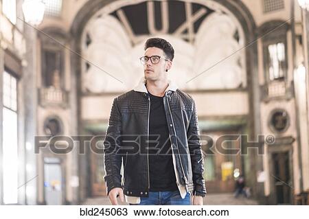 Stock Image - Caucasian man walking in lobby. Fotosearch