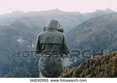 Caucasian man wearing coat looking at valley View Large Photo Image Stock Photography - Caucasian man wearing coat looking at valley. Fotosearch