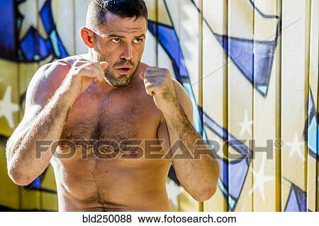 Stock Photo - Caucasian man with bare chest boxing. Fotosearch