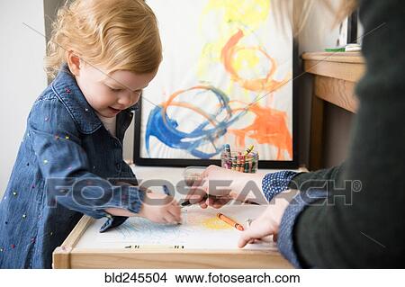 Picture - Caucasian mother and daughter coloring. Fotosearch