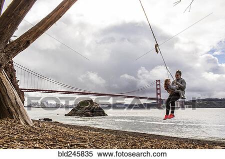 Caucasian mother and daughter on rope spring near bridge View Large Photo Image Stock Photography - Caucasian mother and daughter on rope spring near bridge. Fotosearch