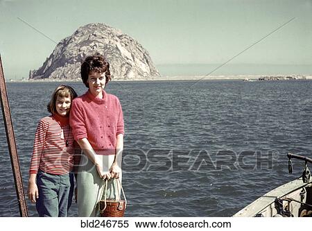 Stock Photography - Caucasian mother and daughter posing near ocean. Fotosearch