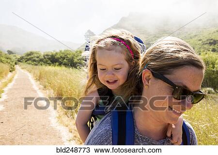 Caucasian mother carrying daughter while hiking View Large Photo Image Stock Image - Caucasian mother carrying daughter while hiking. Fotosearch
